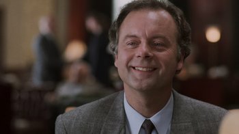 Movie still from “Ghost” (1990), directed by Jerry Zucker – A person wearing a suit and tie; Close Up shot, Low angle