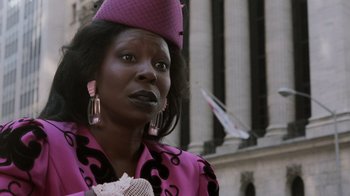 Movie still from “Ghost” (1990), directed by Jerry Zucker – A woman wearing a pink hat and a pink jacket; Close Up shot, Low angle