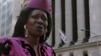 Movie still from “Ghost” (1990), directed by Jerry Zucker – A woman wearing a pink hat and a pink jacket; Close Up shot, Low angle