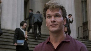 Movie still from “Ghost” (1990), directed by Jerry Zucker – A person wearing a suit and tie; Close Up shot, Low angle