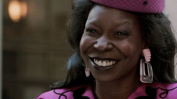Movie still from “Ghost” (1990), directed by Jerry Zucker – A person wearing a hat and smiling; Close Up shot, Over the shoulder angle