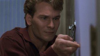 Movie still from “Ghost” (1990), directed by Jerry Zucker – A person holding a chain; Close Up shot, High angle