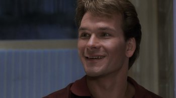 Movie still from “Ghost” (1990), directed by Jerry Zucker – A person smiling; Close Up shot, Low angle