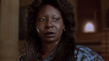 Movie still from “Ghost” (1990), directed by Jerry Zucker – A woman with long black hair wearing a blue shirt; Close Up shot, Low angle