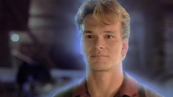 Movie still from “Ghost” (1990), directed by Jerry Zucker – A young man with blonde hair and blue eyes; Close Up shot, Over the shoulder angle