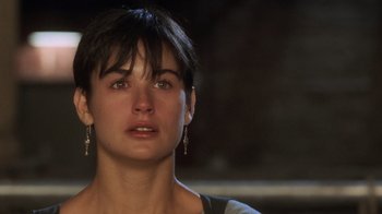 Movie still from “Ghost” (1990), directed by Jerry Zucker – A person with short black hair; Close Up shot, Over the shoulder angle