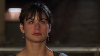 Movie still from “Ghost” (1990), directed by Jerry Zucker – A person with short black hair; Close Up shot, Over the shoulder angle