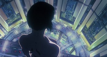 Movie still from “Ghost in the Shell” (1995), directed by Mamoru Oshii – A woman looking out a window at a city; Wide shot, Low angle
