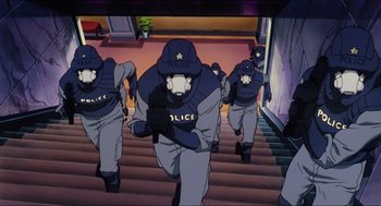 Movie still from “Ghost in the Shell” (1995), directed by Mamoru Oshii – A group of police officers walking down a set of stairs; Wide shot, Low angle