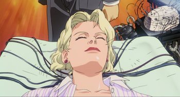 Movie still from “Ghost in the Shell” (1995), directed by Mamoru Oshii – An animated woman laying in a bed next to a man; Close Up shot, Overhead angle