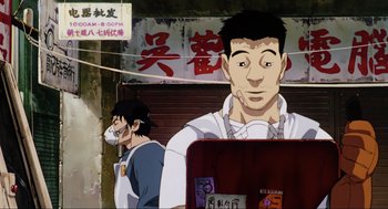 Movie still from “Ghost in the Shell” (1995), directed by Mamoru Oshii – A man standing in front of another man in front of a building; Close Up shot, Low angle