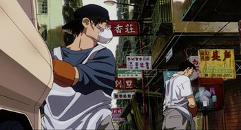 Movie still from “Ghost in the Shell” (1995), directed by Mamoru Oshii – A man wearing a face mask standing in front of a building; Medium shot, Low angle