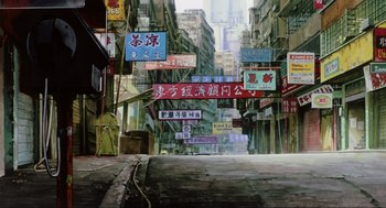Movie still from “Ghost in the Shell” (1995), directed by Mamoru Oshii – An empty street with many signs hanging from it; Extreme Wide shot, Low angle