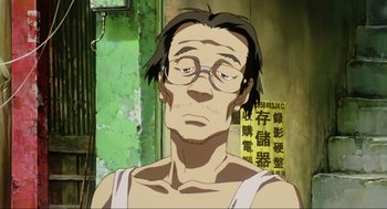 Movie still from “Ghost in the Shell” (1995), directed by Mamoru Oshii – A man with glasses is looking at the camera; Close Up shot, Low angle