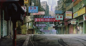 Movie still from “Ghost in the Shell” (1995), directed by Mamoru Oshii – An empty street with many signs hanging from it's sides; Extreme Wide shot, Low angle