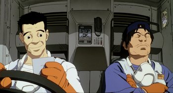 Movie still from “Ghost in the Shell” (1995), directed by Mamoru Oshii – Two men sitting in a car in front of an atm machine; Close Up shot, Low angle