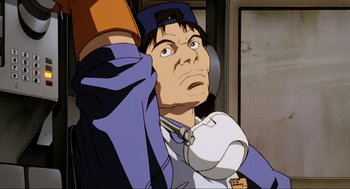 Movie still from “Ghost in the Shell” (1995), directed by Mamoru Oshii – An animated man holding a pair of headphones; Close Up shot, Low angle