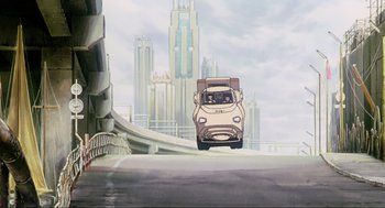 Movie still from “Ghost in the Shell” (1995), directed by Mamoru Oshii – An animated scene of a truck driving down a road; Extreme Wide shot, Low angle