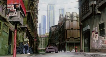Movie still from “Ghost in the Shell” (1995), directed by Mamoru Oshii – An image of an asian street scene with a car parked on the side of the road; Extreme Wide shot, Low angle