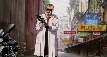 Movie still from “Ghost in the Shell” (1995), directed by Mamoru Oshii – An animated man in a white coat and red tie standing in the middle of an alley; Medium shot, Low angle