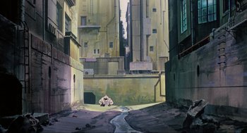 Movie still from “Ghost in the Shell” (1995), directed by Mamoru Oshii – An animated scene of a man sitting in the middle of an alley; Extreme Wide shot, High angle