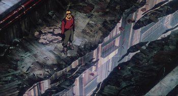 Movie still from “Ghost in the Shell” (1995), directed by Mamoru Oshii – A man standing on the side of a building; Wide shot, Overhead angle