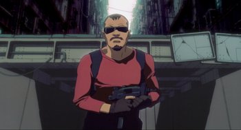 Movie still from “Ghost in the Shell” (1995), directed by Mamoru Oshii – A man in a red shirt holding a gun in his hands; Medium shot, Low angle