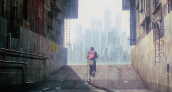 Movie still from “Ghost in the Shell” (1995), directed by Mamoru Oshii – A man walking down a street with a city in the background; Extreme Wide shot, Low angle