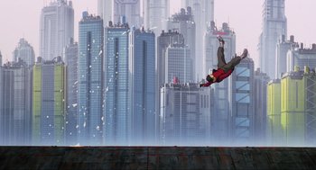 Movie still from “Ghost in the Shell” (1995), directed by Mamoru Oshii – A man flying through the air on top of a skateboard; Extreme Wide shot, Low angle