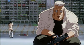 Movie still from “Ghost in the Shell” (1995), directed by Mamoru Oshii – An old man is holding a gun in a city; Medium shot, Low angle