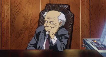 Movie still from “Ghost in the Shell” (1995), directed by Mamoru Oshii – An old man sitting in an office chair with his hand under his chin; Medium shot, High angle