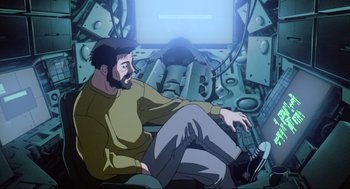 Movie still from “Ghost in the Shell” (1995), directed by Mamoru Oshii – A man sitting on a chair in front of a computer screen; Medium shot, High angle