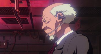 Movie still from “Ghost in the Shell” (1995), directed by Mamoru Oshii – An old man with a white beard is wearing a headset; Close Up shot, Low angle