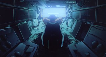 Movie still from “Ghost in the Shell” (1995), directed by Mamoru Oshii – An image of a man sitting in a chair in a room; Wide shot, High angle