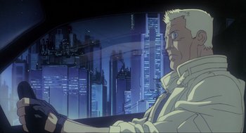 Movie still from “Ghost in the Shell” (1995), directed by Mamoru Oshii – A man in white shirt holding a steering wheel in front of a city; Medium shot, Low angle