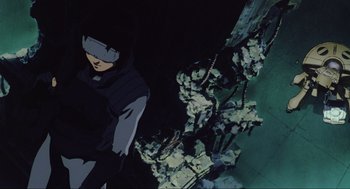 Movie still from “Ghost in the Shell” (1995), directed by Mamoru Oshii – An animated scene of a man standing in the dark; Medium shot, Low angle