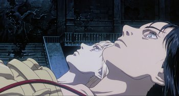 Movie still from “Ghost in the Shell” (1995), directed by Mamoru Oshii – A man and a woman looking at a laptop computer; Close Up shot, Low angle