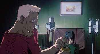 Movie still from “Ghost in the Shell” (1995), directed by Mamoru Oshii – An animated scene of a man and a woman in a living room; Medium shot, Low angle