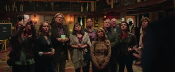 Movie still from “Ghostbusters” (2016), directed by Paul Feig – A group of people standing in front of a library; Medium shot, High angle