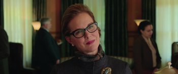 Movie still from “Ghostbusters” (2016), directed by Paul Feig – A person wearing glasses and a jacket; Close Up shot, Over the shoulder angle