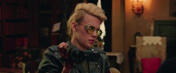 Movie still from “Ghostbusters” (2016), directed by Paul Feig – A woman holding a video camera while wearing a leather jacket; Close Up shot, Over the shoulder angle