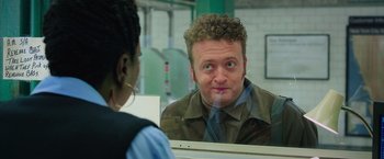 Movie still from “Ghostbusters” (2016), directed by Paul Feig – A man looking at himself in the mirror; Close Up shot, Over the shoulder angle