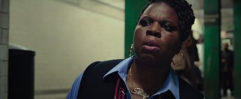 Movie still from “Ghostbusters” (2016), directed by Paul Feig – A person wearing a suit and tie; Close Up shot, Over the shoulder angle