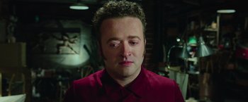 Movie still from “Ghostbusters” (2016), directed by Paul Feig – A person wearing a red shirt; Close Up shot, High angle