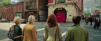Movie still from “Ghostbusters” (2016), directed by Paul Feig – A group of people walking down a street; Wide shot, Over the shoulder angle