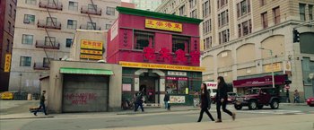 Movie still from “Ghostbusters” (2016), directed by Paul Feig – People walking down the street in front of an asian restaurant; Extreme Wide shot, High angle