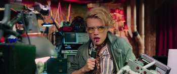 Movie still from “Ghostbusters” (2016), directed by Paul Feig – A woman with a cigarette in her mouth; Medium shot, Low angle