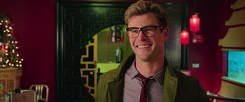 Movie still from “Ghostbusters” (2016), directed by Paul Feig – A man wearing glasses and a green jacket; Close Up shot, Over the shoulder angle