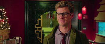 Movie still from “Ghostbusters” (2016), directed by Paul Feig – A person wearing glasses and a jacket; Close Up shot, Over the shoulder angle