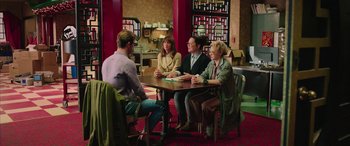 Movie still from “Ghostbusters” (2016), directed by Paul Feig – A group of people sitting at a table in a restaurant; Wide shot, Over the shoulder angle